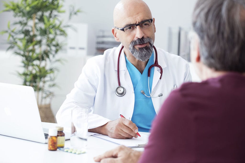 a doctor discusses mental health and physical health with a patient