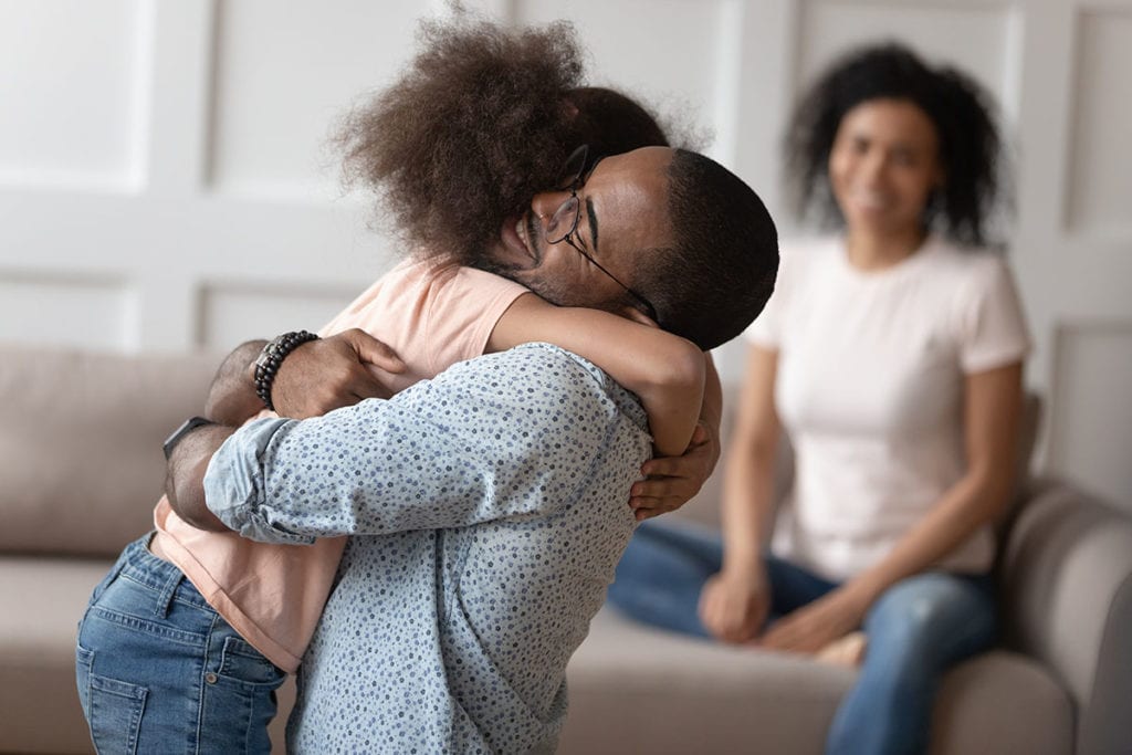 A man hugs his daughter after learning that she struggles with eating disorders and alcoholism