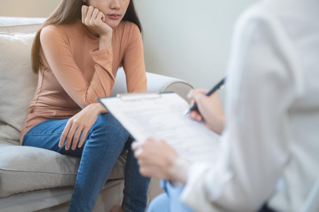 woman sitting on couch talks with therapist about an ADHD chemical imbalance