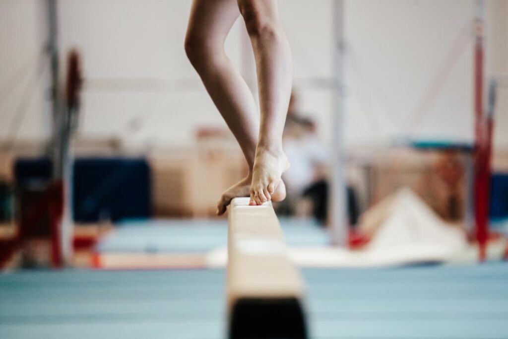 a gymnast balances on a balancing beam
