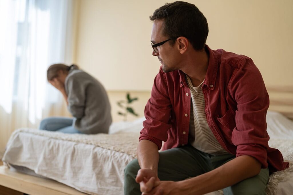 Man looks over at wife crying, who is dealing with narcissism and shame