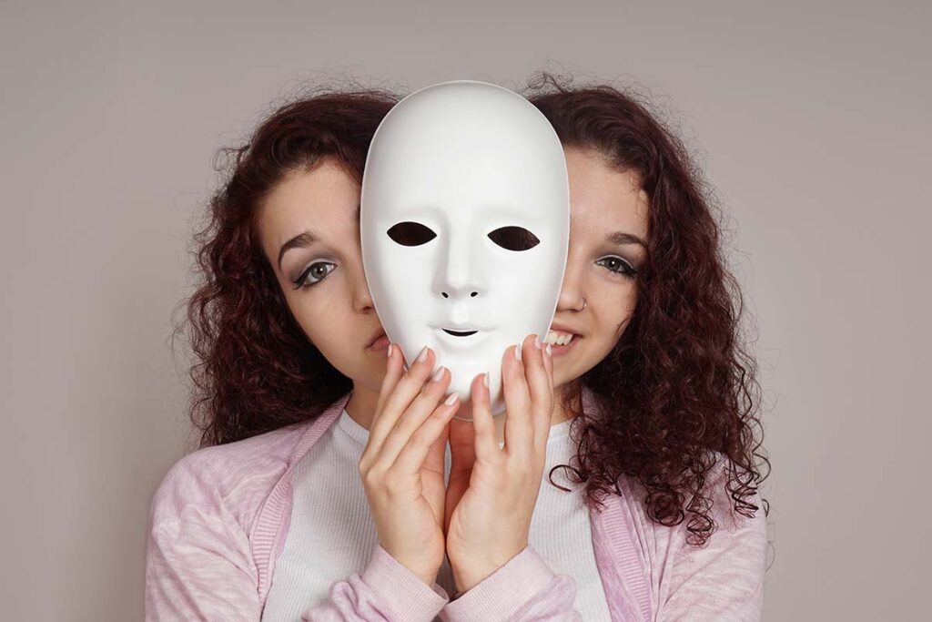 woman holding mask and experiencing the signs of borderline personality disorder