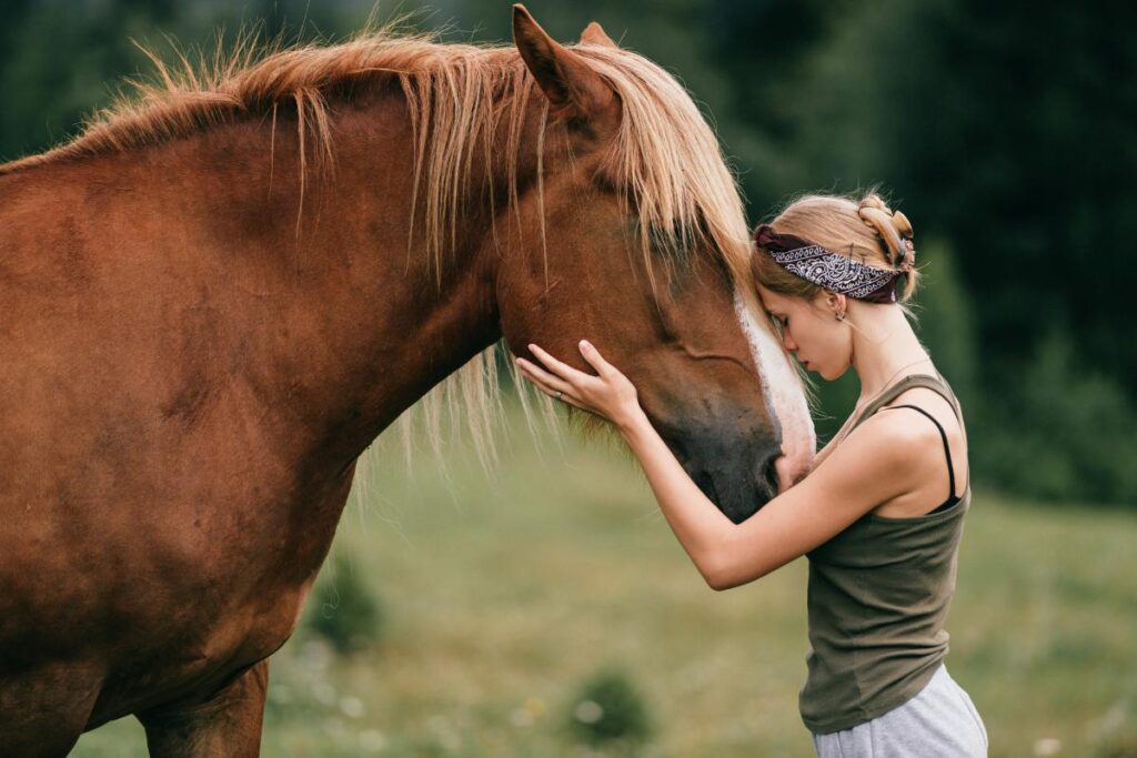 Young woman engaged in equine therapy for trauma