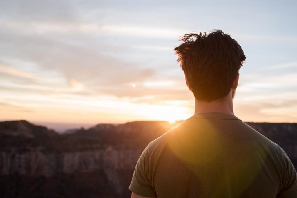 man looking at sunset considers the alcohol detox timeline