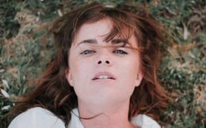 troubled woman laying in grass thinking of inpatient anxiety treatment centers