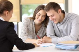 insurance businesswoman provides cigna rehab insurance coverage papers for happy couple to sign