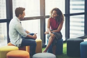 man and woman sit together talking in a hallucinogen addiction treatment center