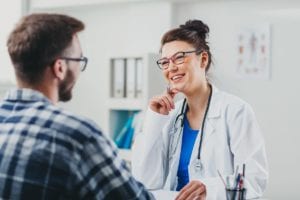 male patient talks to one of the licensed rehab therapists in the facility