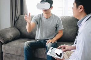 therapist talks through patient using a vr headset for reality therapy programs