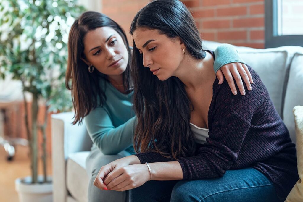 woman comforts friend after experiencing xanax overdose symptoms