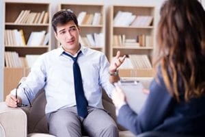 man talking to therapist at acute stress disorder treatment center