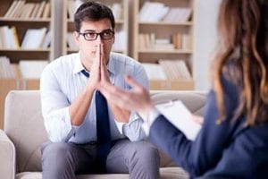 man listening to therapist at panic disorder treatment center