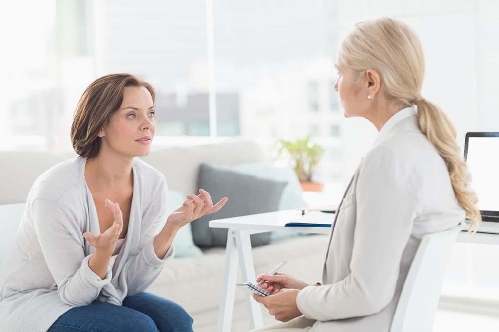 woman asking intake specialist what is psychotherapy