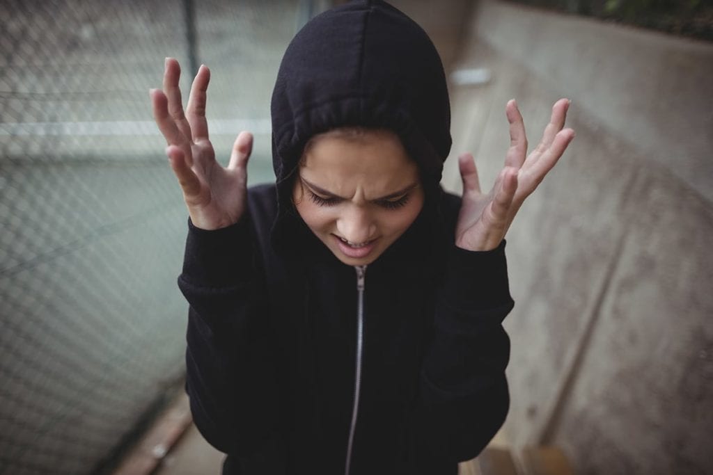 A woman screams as she experiences symptoms of anger disorder