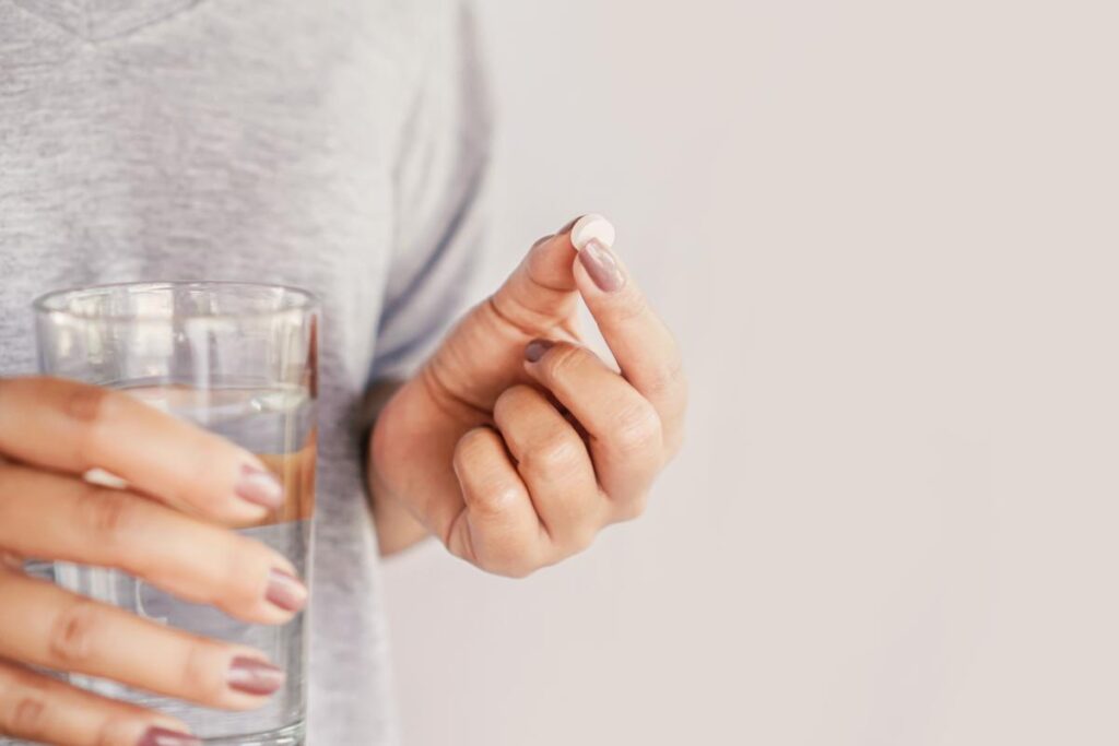 woman holding pill learning the facts about oxycontin