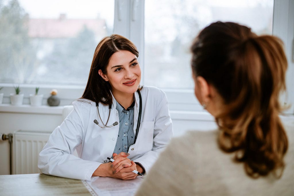 a woman talks to her doctor about dangerous prescription medications