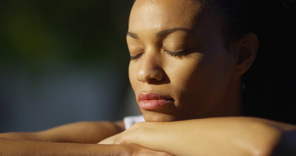 a woman closes her eyes as she thinks about information about stimulant withdrawal