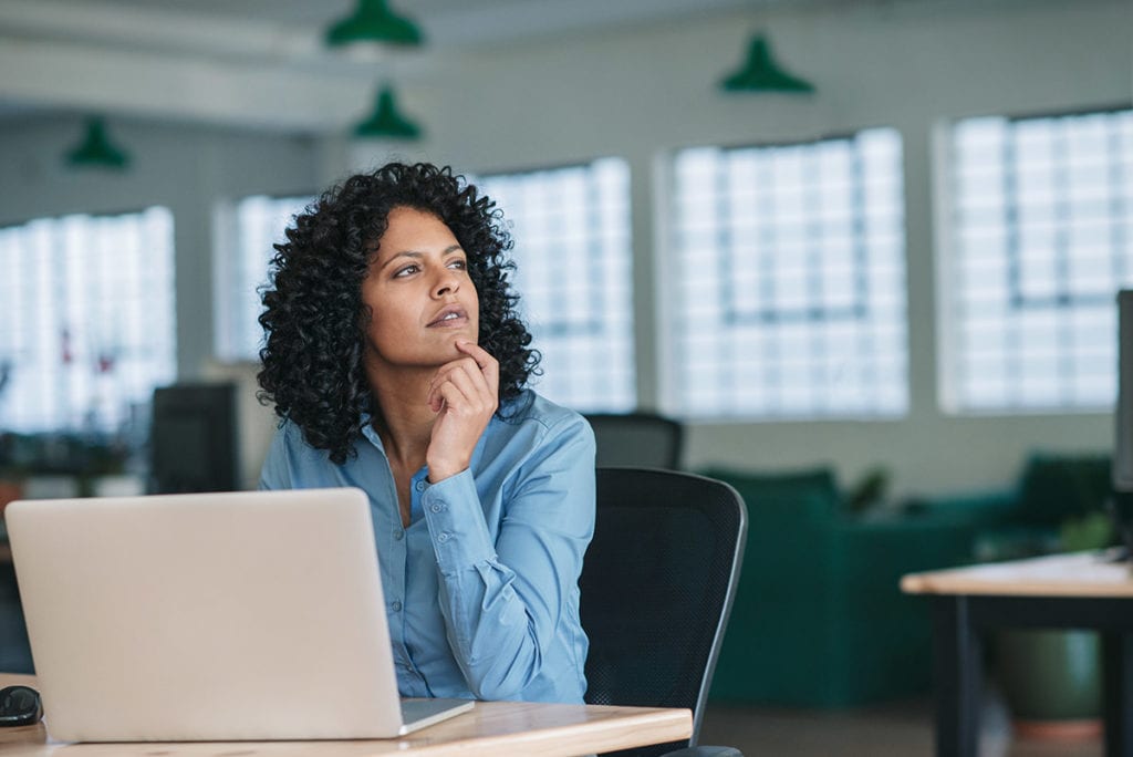 a woman at a computer taps her chin as she wonders what is a speed drug