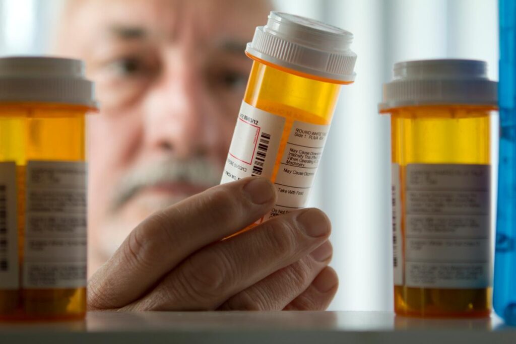 man looking at addictive prescription painkillers