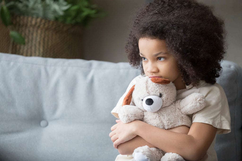 a child holding a teddy bear wonders if she'll have to deal with childhood trauma and addiction