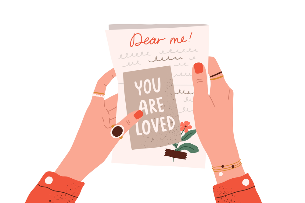 Hands holding self-love letter