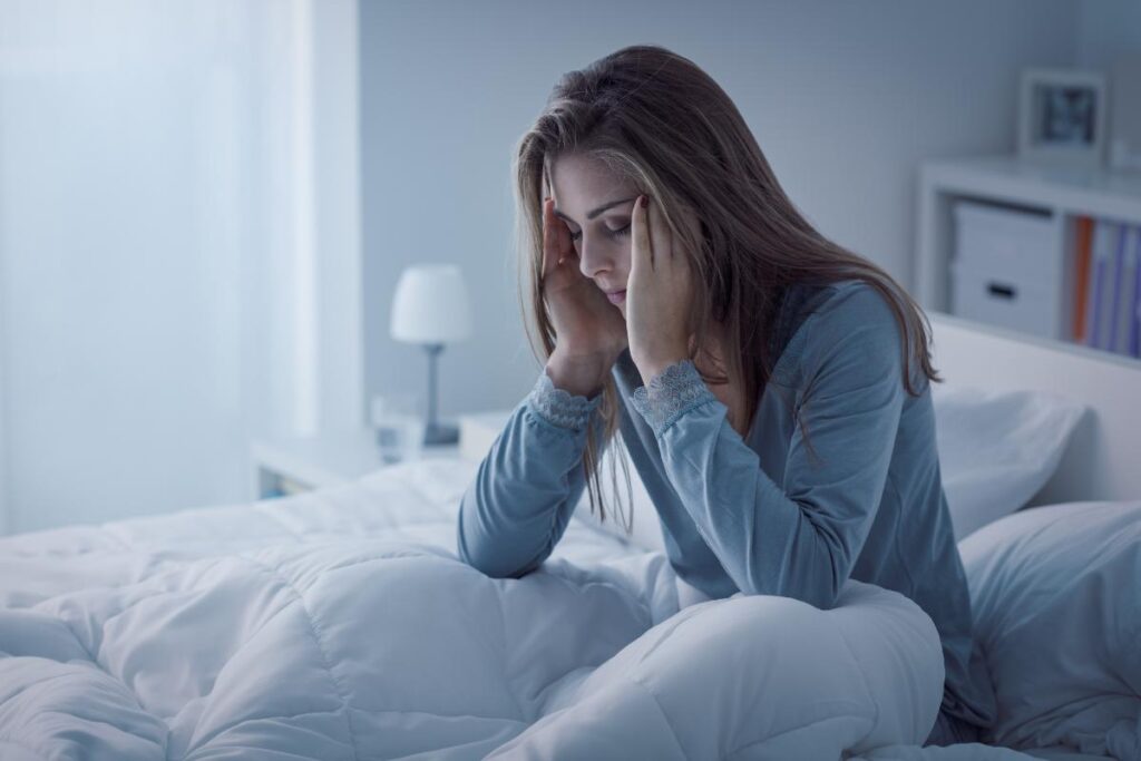 woman in bed considering the signs of benzo abuse