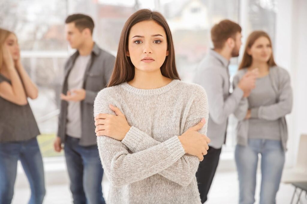 woman in sweater avoiding others wondering about avoidant personality disorder vs social anxiety