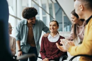 woman in a non-12-step drug rehab center is cheered on by her peers