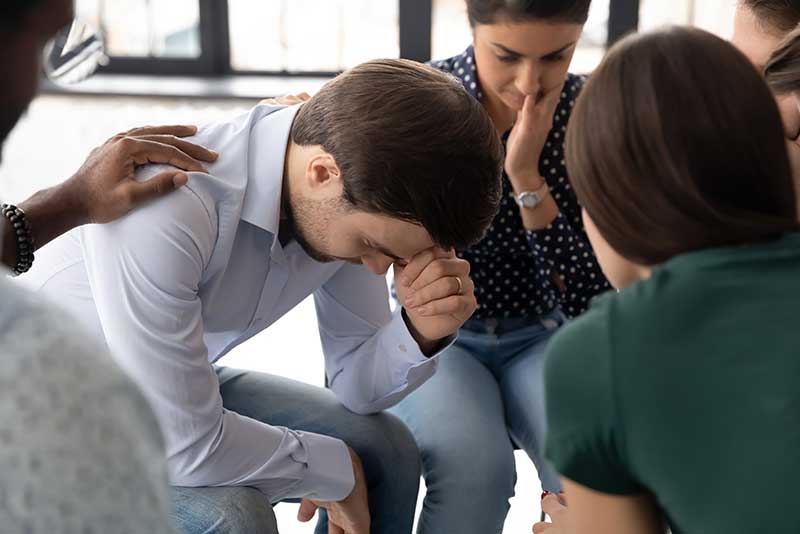 Man receiving support in group therapy at an benzo addiction treatment center