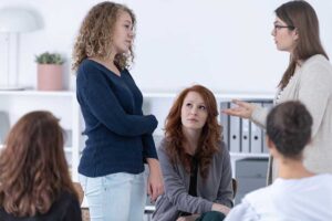 Woman participating in group therapy at a women's addiction treatment center