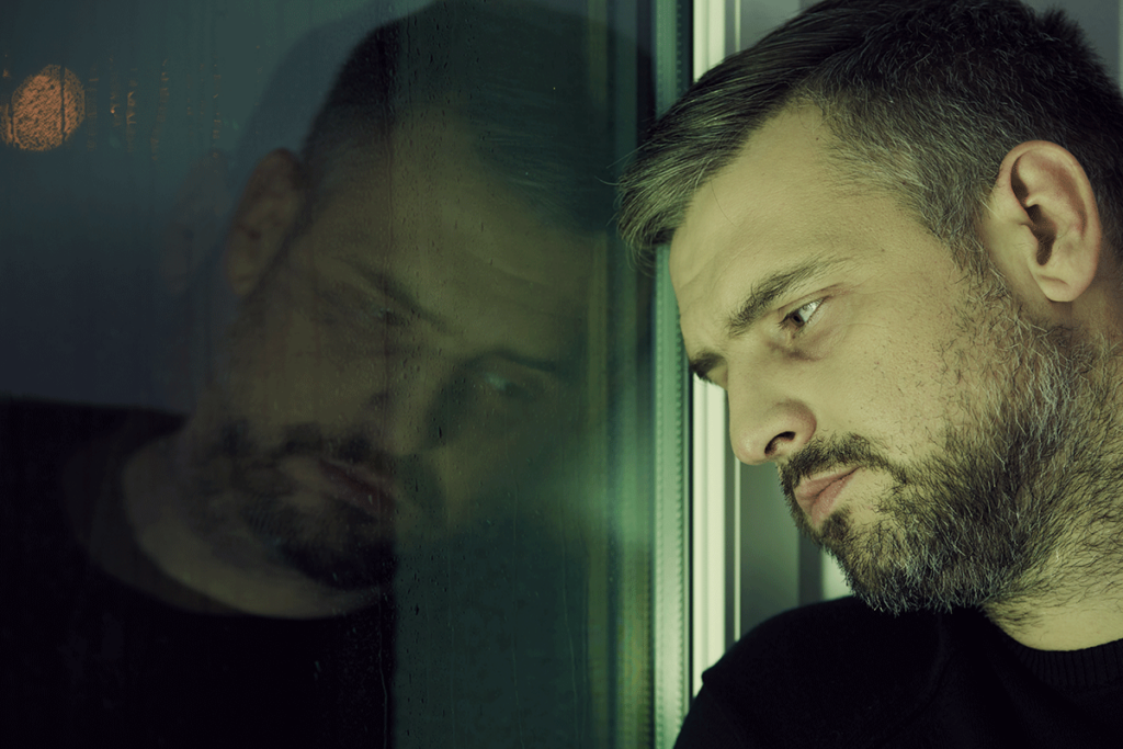 Man thinking about signs of oxycodone addiction