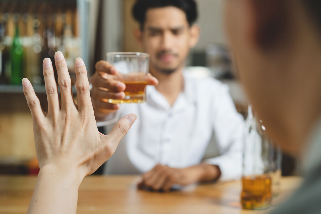 A person asking, "Can an alcoholic drink in moderation?"