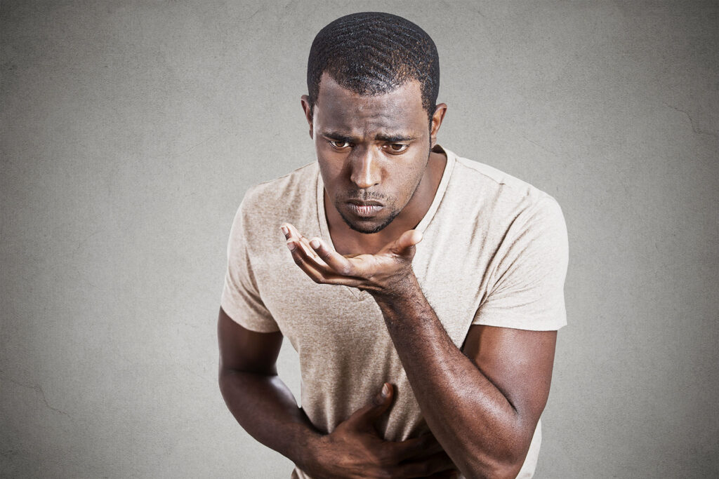 Man wondering, "What are the symptoms of alcoholic liver disease?"