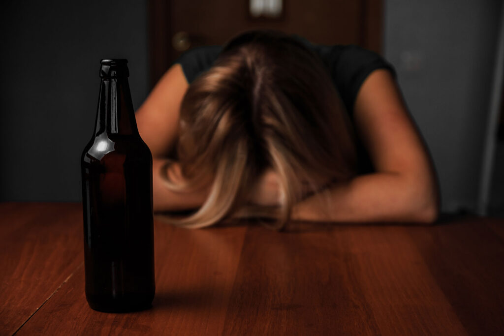 Woman wondering, "What are the effects of alcohol on sleep?"