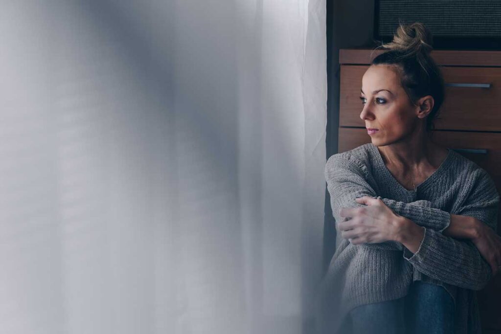 A woman thinking about cocaine side effects